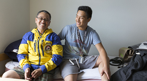 Father and student in residence hall room