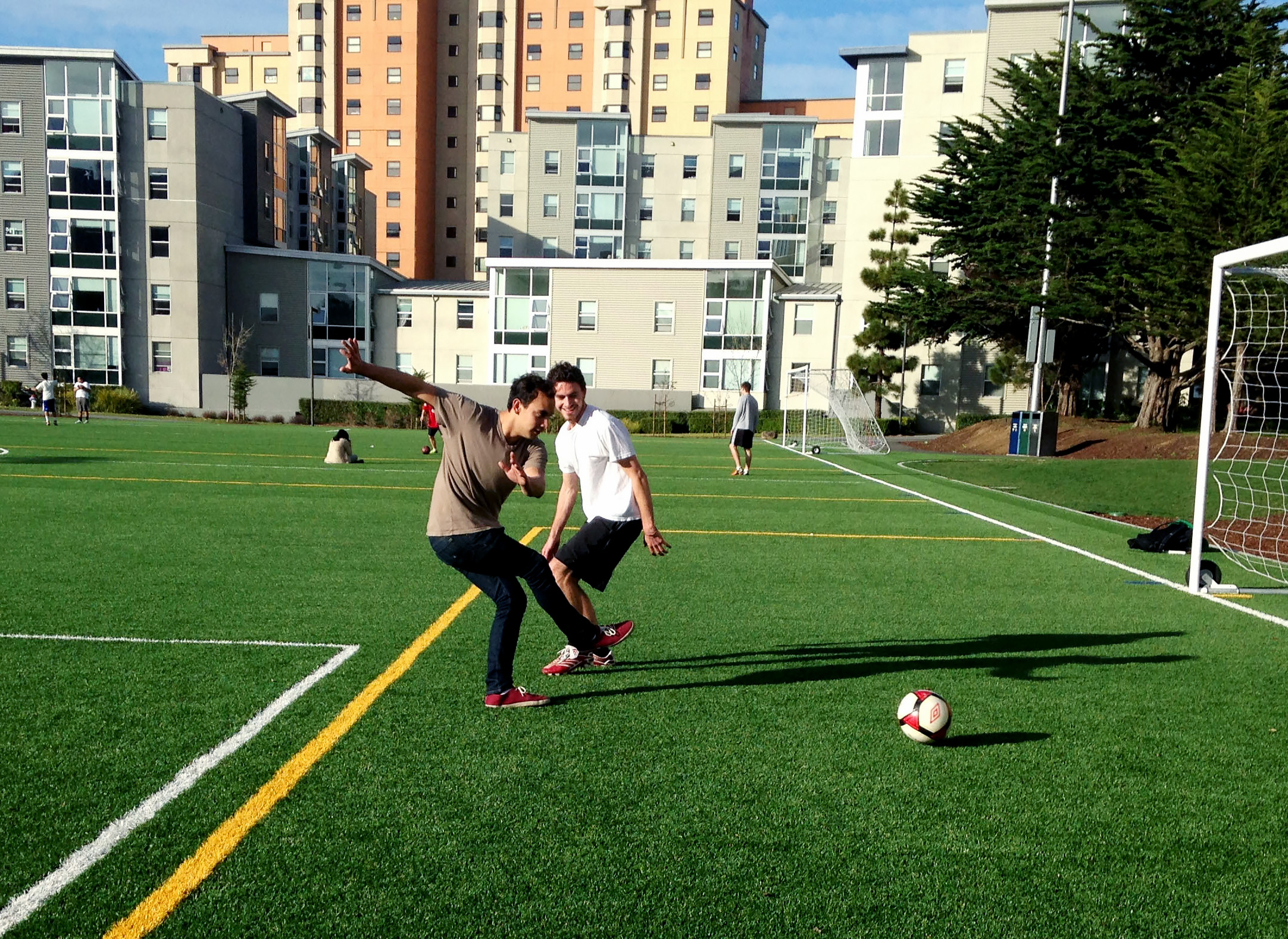 Students playing soccer on West Campus Green