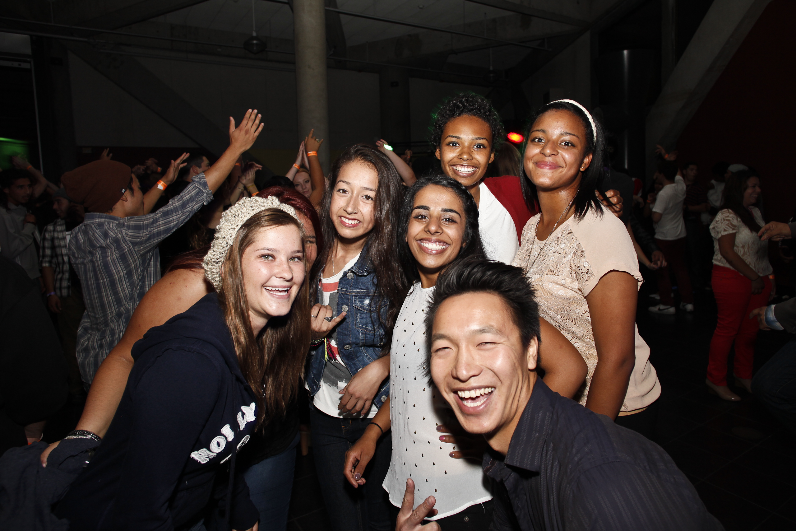 Diverse group of students posing and smiling at an event